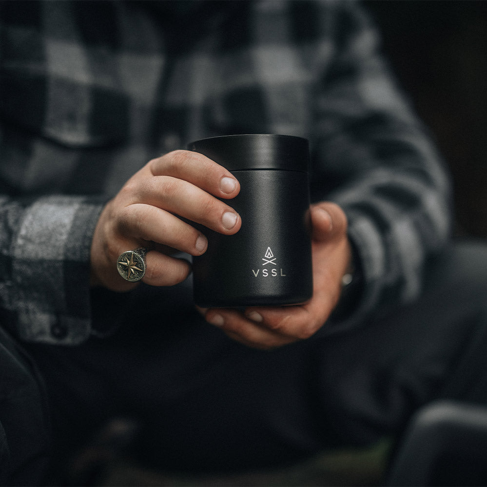 man holding vssl coffee mug